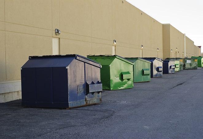 construction debris is tossed into a dumpster on site in Mascotte, FL